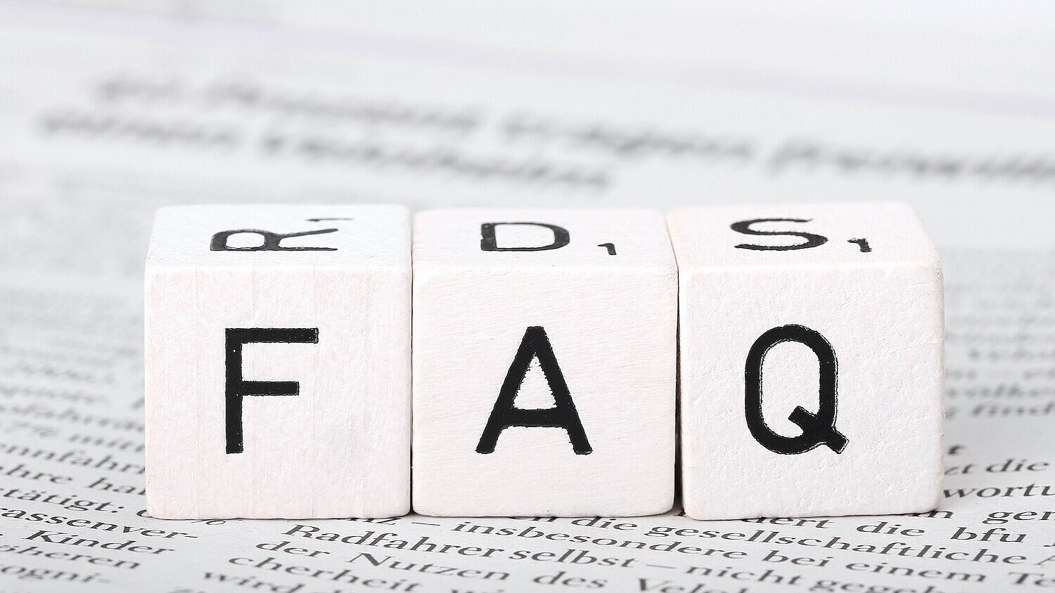 Drei Würfel mit den Buchstaben "F", "A" und "Q". 